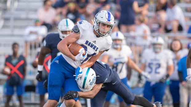 DII tight end Kyle Morlock running the football to avoid a tackle.